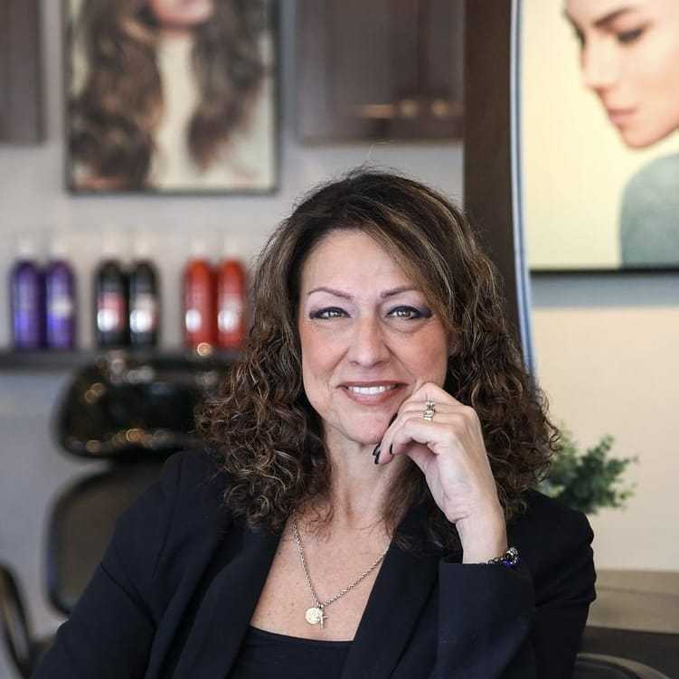 Portrait of Angela, a professional stylist at Juliana's Salon, showcasing their expertise and style.